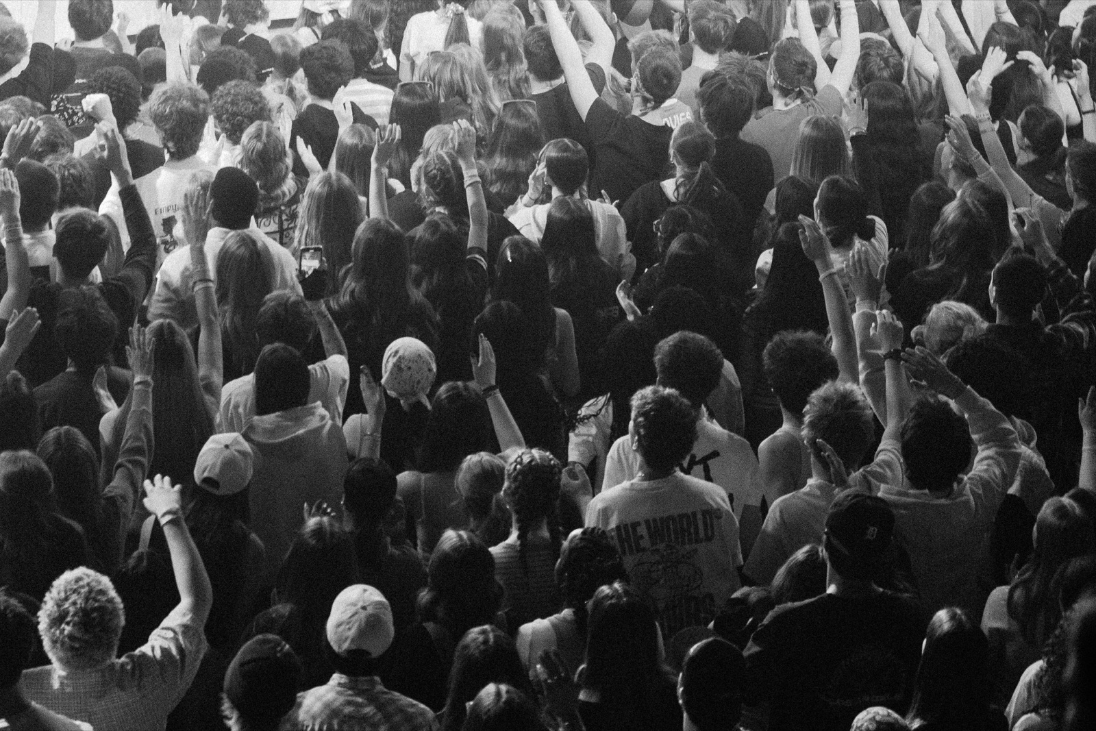 Crowd raising their hands during worship at a Rally