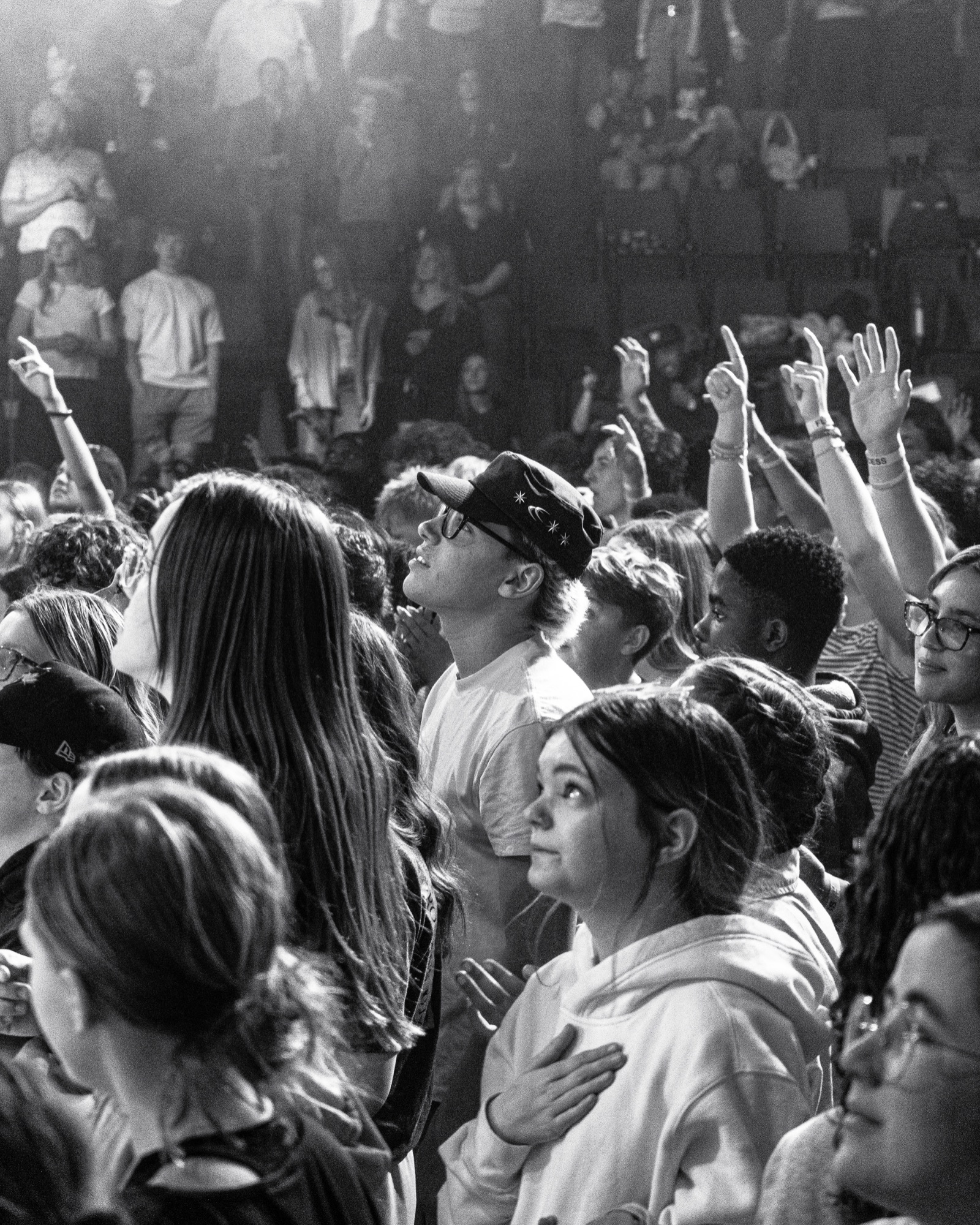 Rally attendees responding in worship with raised hands